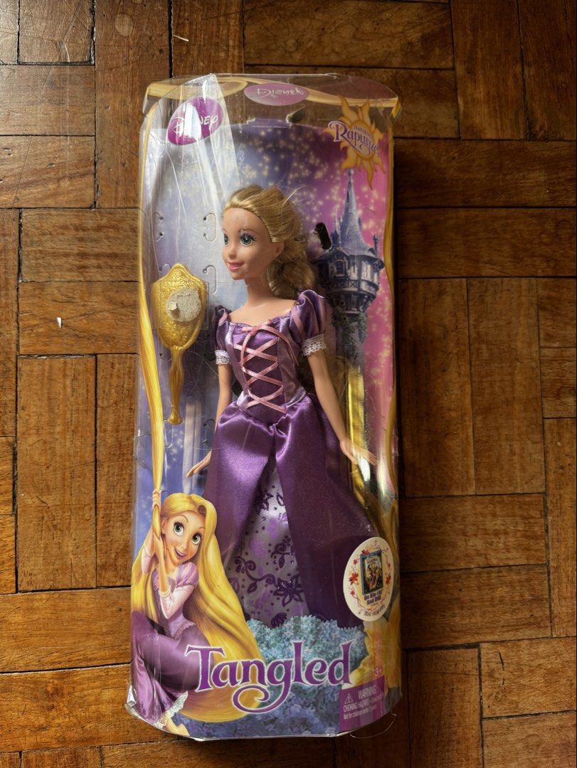 Official Pre-loved Tangled Rapunzel Doll (Category: Figurines & Statues) located in Manila. Submitted by wisefox_401c59 (Listing ID 1445276147, Image 1). Description: Doll is intact with no flaws Comes with shoes and hairbrush Box is opened.