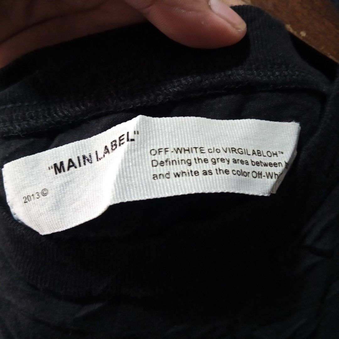 OFF-WHITE "MAIN LABEL" Black Graphic T-Shirt 2013 (Category: Tshirts & Polo Shirts ) located in Lucban. Submitted by aeronroyyy (Listing ID 1445330125, Image 3). Description: - Authentic 2013 Black OFF-WHITE T-shirt - Features iconic OFF-WHITE arrows graphic on the back - Small OFF-WHITE logo detail on the front - Made with quality materials - Essential piece for any streetwear collection.
