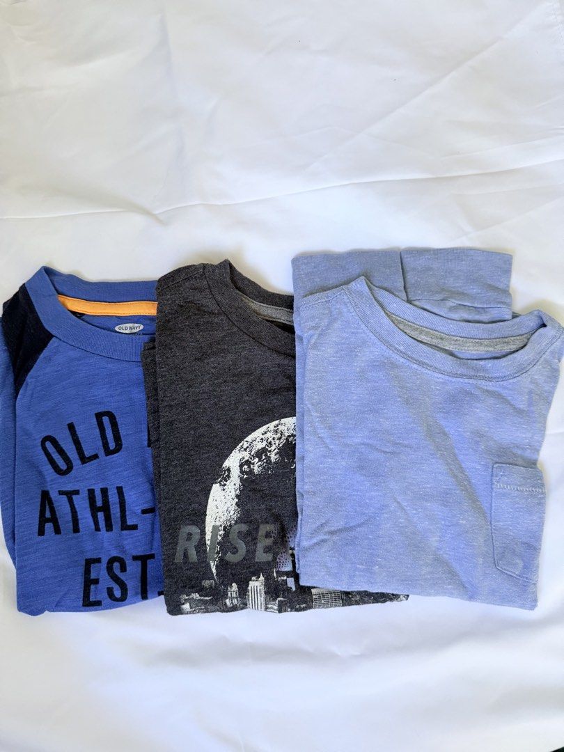 Old Navy Boys' T-shirts Bundle (Size XS/TP) (Category: Babies & Kids Fashion) located in Marilao. Submitted by mebslerman (Listing ID 1445411205, Image 1). Description: - Bundle of 3 Old Navy t-shirts for boys. - Sizes: XS or TP (Extra Small / Teen Petite). - Includes: - Blue raglan tee with 'Old Navy Athl-Dept Est. 94' graphic. - Dark grey tee with city skyline and basketball graphic. - Light blue pocket tee. - Condition: Minor marks noted on th