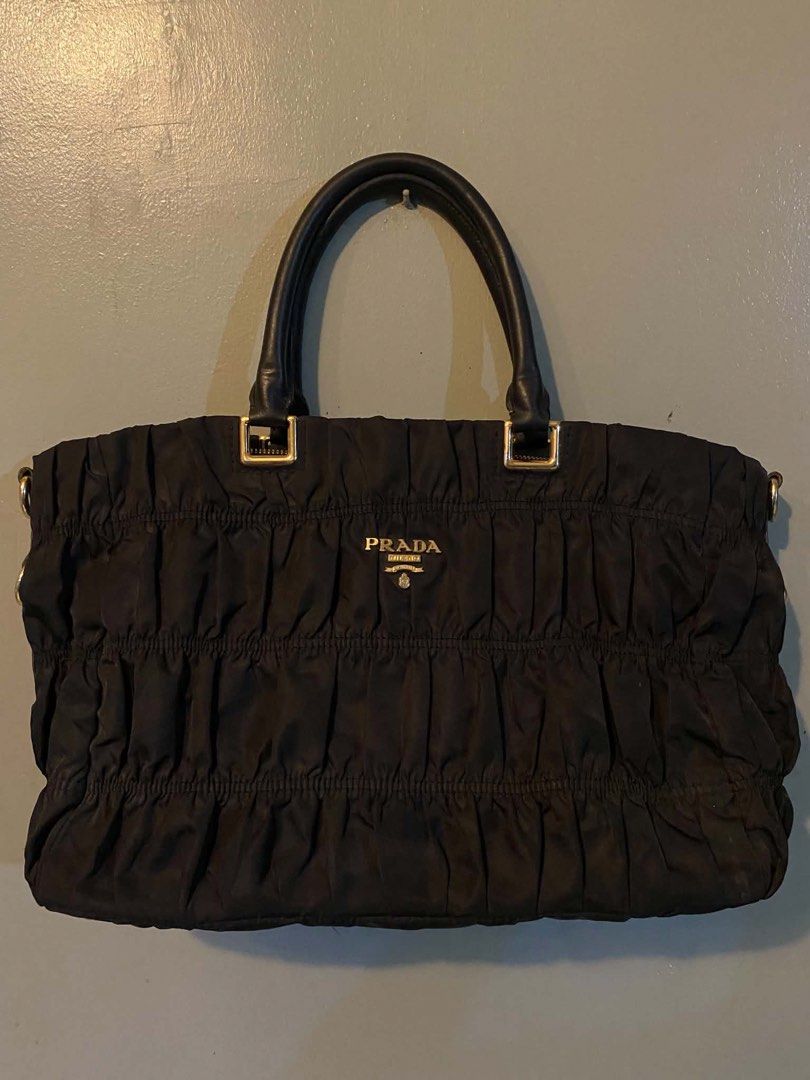 Prada Gaufre Tote Tessuto Nylon (Category: Luxury Bags & Wallets) located in Cagayan de Oro. Submitted by timeless.ph (Listing ID 1445340798, Image 2). Description: Material: Tesutto Nylon Features: Distinct gathered texture, a taised gold-tone prada metal logo Condition: Rank AB Issue: Missing sling & removed main puller (still working and has the removed puller kept).