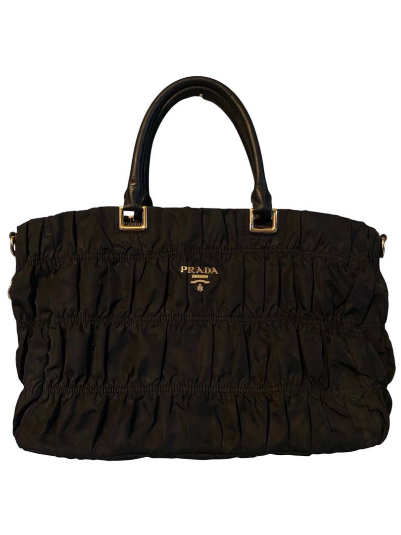 Prada Gaufre Tote Tessuto Nylon (Category: Luxury Bags & Wallets) located in Cagayan de Oro. Submitted by timeless.ph (Listing ID 1445340798, Image 1). Description: Material: Tesutto Nylon Features: Distinct gathered texture, a taised gold-tone prada metal logo Condition: Rank AB Issue: Missing sling & removed main puller (still working and has the removed puller kept).