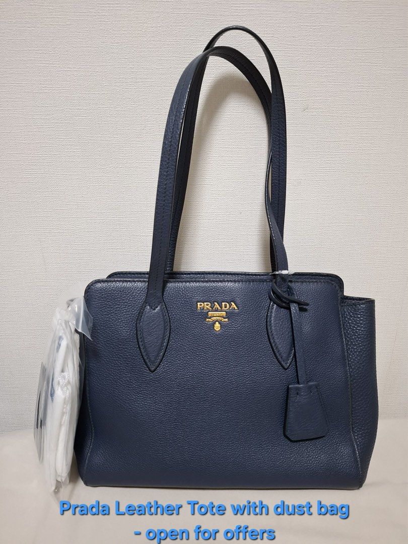 Prada Leather Tote Bag with Dust Bag (Category: Luxury Bags & Wallets) located in San Juan City. Submitted by bitznera69262 (Listing ID 1445408497, Image 1). Description: - Navy blue Prada leather tote - Includes original dust bag - Classic and versatile design, perfect for daily use - Open to reasonable offers - Feel free to ask any questions!.
