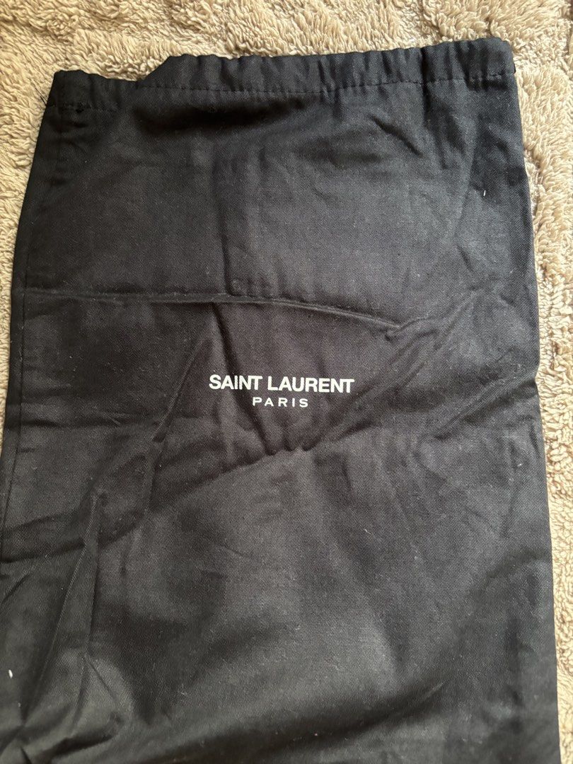 Saint Laurent Paris Dust Bag (Category: Luxury Bags & Wallets) located in Manila. Submitted by livfindsph (Listing ID 1445263810, Image 1). Description: - Authentic Saint Laurent dust bag - Color: Black exterior with white logo - Interior: White lining - Closure: Drawstring - Ideal for protecting luxury bags, shoes, and other valuable items.