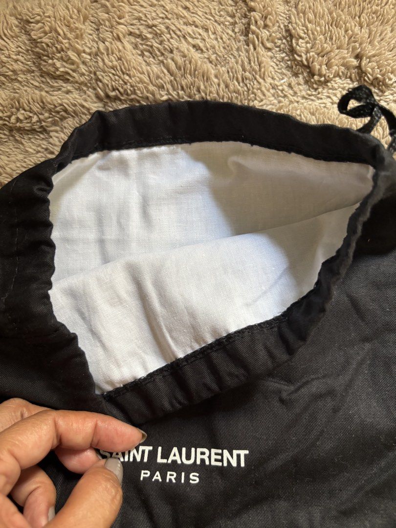 Saint Laurent Paris Dust Bag (Category: Luxury Bags & Wallets) located in Manila. Submitted by livfindsph (Listing ID 1445263810, Image 3). Description: - Authentic Saint Laurent dust bag - Color: Black exterior with white logo - Interior: White lining - Closure: Drawstring - Ideal for protecting luxury bags, shoes, and other valuable items.