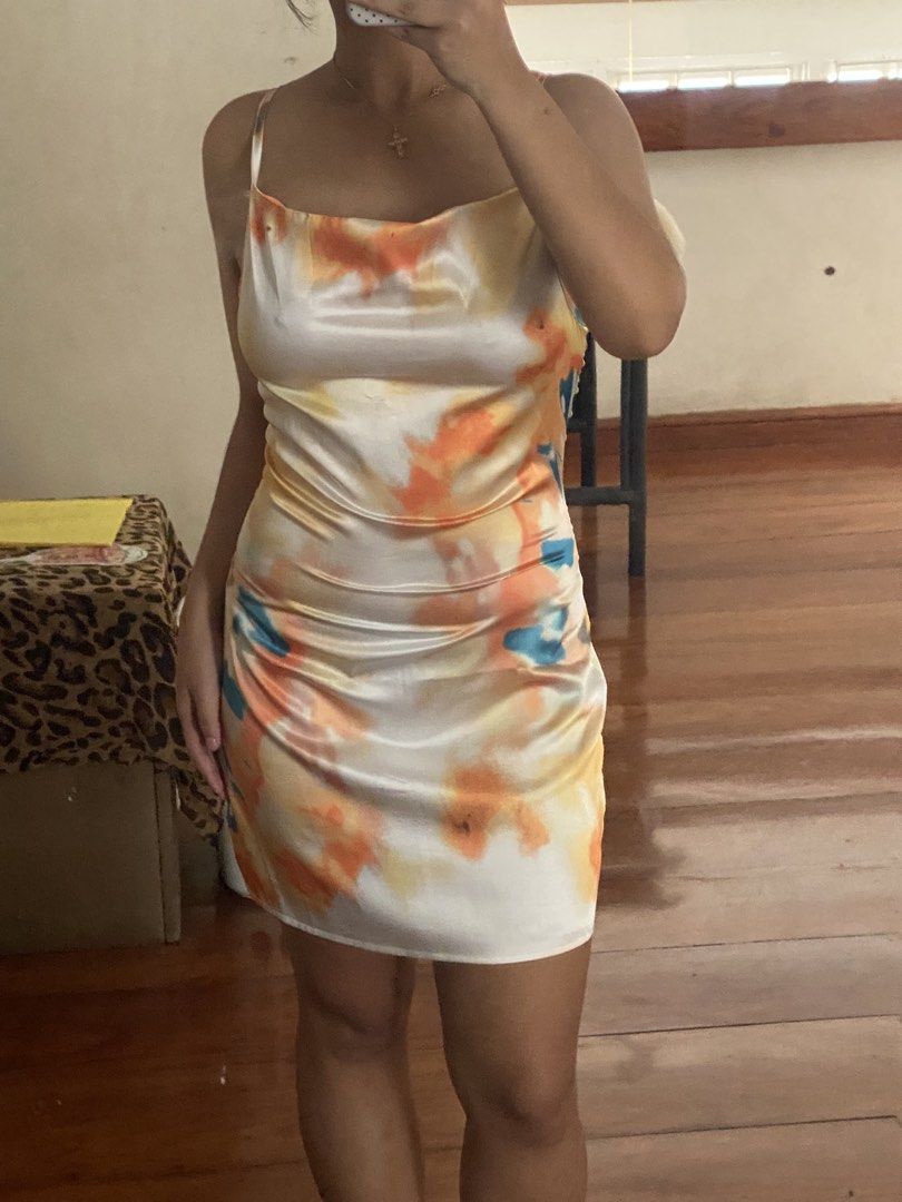 satin dress (Category: Dresses) located in Paranaque City. Submitted by declutterwdebi (Listing ID 1445271795, Image 2). Description: - Adorable satin slip dress with a vibrant tie-dye print. - Colors: Orange, yellow, and blue. - Stylish cowl neck and delicate spaghetti straps. - Flattering ruched detailing on the side. - Versatile for a night out or a casual day look..