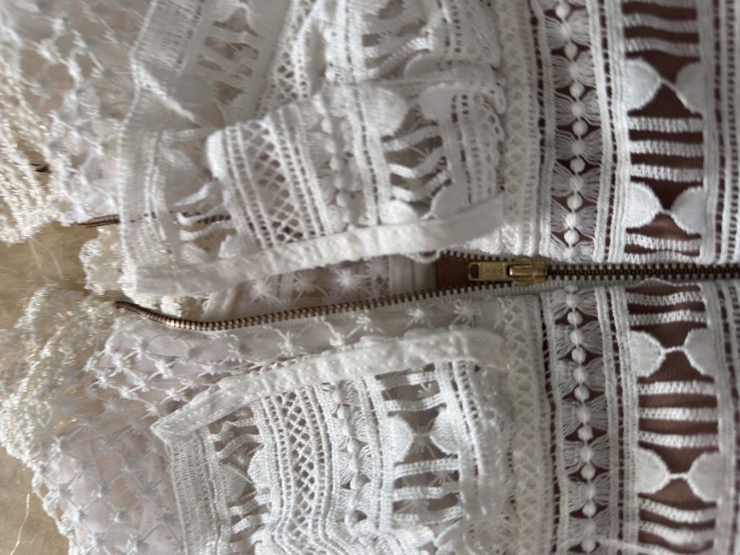 Self-Portrait White Lace Dress (Category: Dresses) located in Manila. Submitted by jessj30 (Listing ID 1445257785, Image 3). Description: - Elegant white lace midi dress by Self-Portrait. - Features intricate cut-out details for a sophisticated look. - Designed with a flattering silhouette to enhance your figure. - Midi length for a chic and versatile style. - Concealed back zipper for a seamless finish. - Ideal for special occasions, parties, or