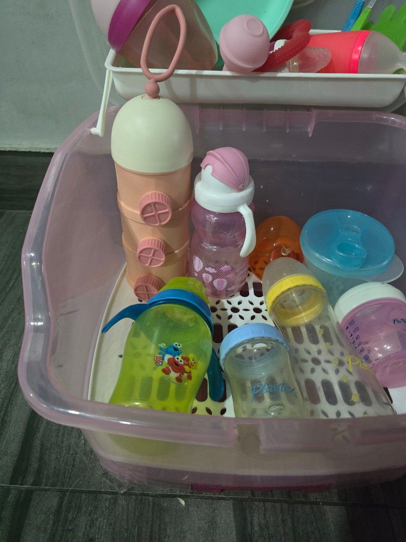 Take all !! Baby Bottle Drying Rack and Storage Container with Accessories (Category: Breastfeeding & Bottle Feeding) located in Makati City. Submitted by zshar (Listing ID 1445302870, Image 3). Description: - Portable baby bottle drying rack and storage box - Includes baby bottles, sippy cups, plate, and utensils - Multiple holders for bottles and accessories - Clear lid for dust-free storage - Perfect for travel or home use - Easy to clean and 