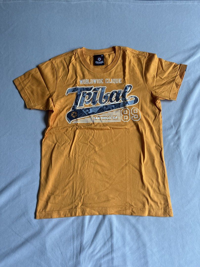 Tribal Yellow T- Shirt (Category: Tshirts & Polo Shirts ) located in Aroroy. Submitted by nicadeclutterz (Listing ID 1445319481, Image 1). Description: • TRIBAL SHIRT - original - vintage - in good condition - size M - colors may appear lighter or darker due to lighting - manage expectations as this item is preloved - dm for more details ☺️ dimes: length: 27 width: 20 💰MOP: GCASH/BDO/GO TYME 🚚 MOP: JNT/LBC .