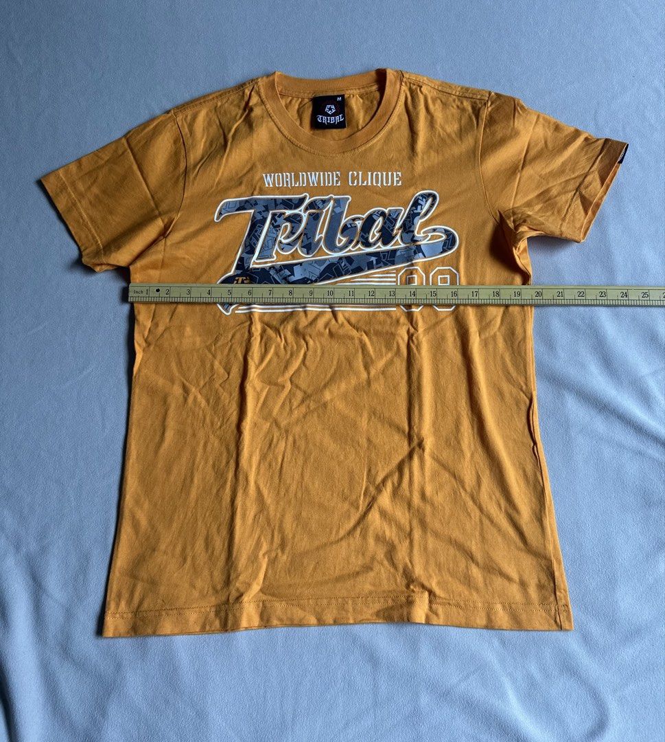 Tribal Yellow T- Shirt (Category: Tshirts & Polo Shirts ) located in Aroroy. Submitted by nicadeclutterz (Listing ID 1445319481, Image 2). Description: • TRIBAL SHIRT - original - vintage - in good condition - size M - colors may appear lighter or darker due to lighting - manage expectations as this item is preloved - dm for more details ☺️ dimes: length: 27 width: 20 💰MOP: GCASH/BDO/GO TYME 🚚 MOP: JNT/LBC .