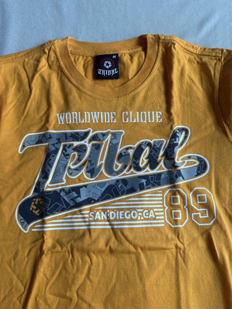 Tribal Yellow T- Shirt (Category: Tshirts & Polo Shirts ) located in Aroroy. Submitted by nicadeclutterz (Listing ID 1445319481, Image 3). Description: • TRIBAL SHIRT - original - vintage - in good condition - size M - colors may appear lighter or darker due to lighting - manage expectations as this item is preloved - dm for more details ☺️ dimes: length: 27 width: 20 💰MOP: GCASH/BDO/GO TYME 🚚 MOP: JNT/LBC .