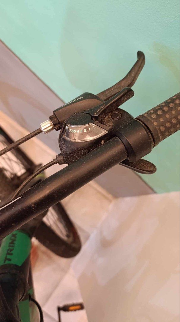 TRINX Mountain Bike (Category: Bicycles) located in Cabuyao City. Submitted by seokjinspree (Listing ID 1445378023, Image 3). Description: - TRINX Mountain Bike - Color: Black and Green frame - Brakes: Disc brakes (front and rear) - Shifters: Shimano - Tires: Flat, require pumping or replacement - Features: Kickstand included - Condition: Ready for repair and riding.