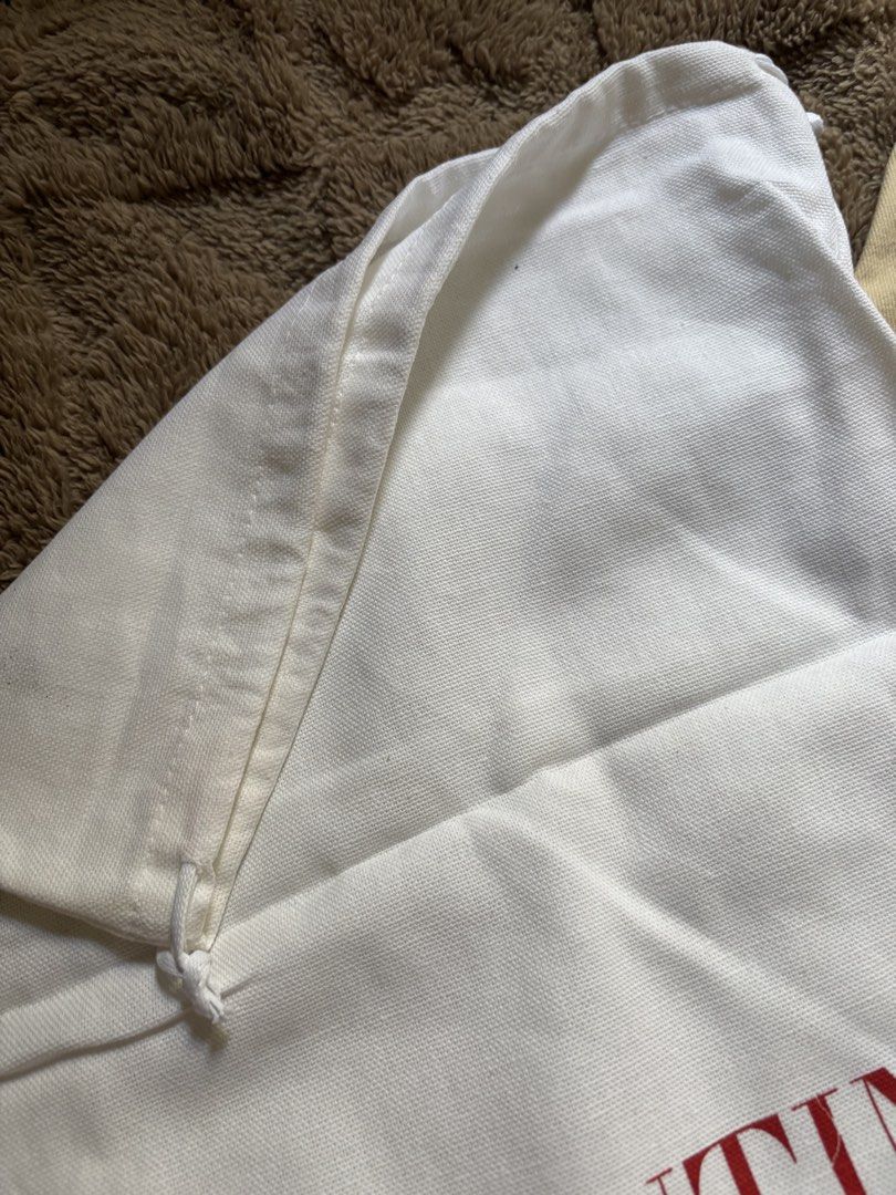 Valentino Garavani Dust Bag (Category: Luxury Bags & Wallets) located in Manila. Submitted by livfindsph (Listing ID 1445264196, Image 2). Description: - Authentic Valentino Garavani dust bag - White canvas material - Features iconic red logo - Secure drawstring closure - Ideal for protecting designer bags and shoes - Keeps items safe and dust-free.