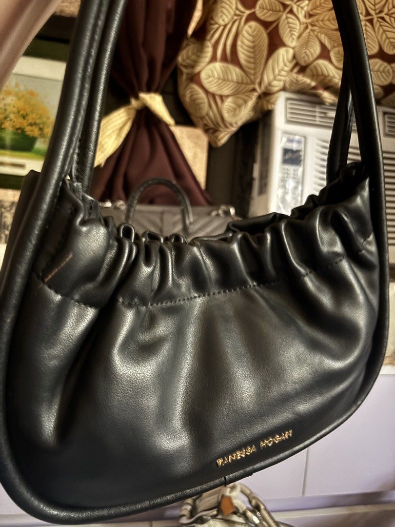 Vanessa Hogan Black Ruched Leather Shoulder Bag (Category: Shoulder Bags) located in Balanga. Submitted by bearsellerr (Listing ID 1445309765, Image 2). Description: - Black Vanessa Hogan shoulder bag - Made of soft, ruched leather - Elegant gold tone hardware details - Secure magnetic snap closure - Lined interior with a zipped pocket - Smooth leather handle - Beautiful, classic shape - Ideal for everyday use.