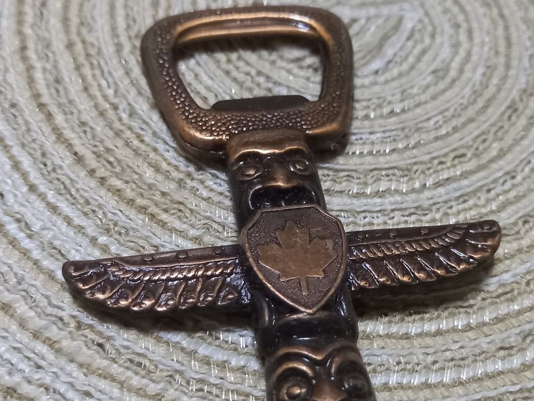 Vintage Totem Pole Bottle Opener (Category: Vintage Collectibles) located in Manila. Submitted by riaring88 (Listing ID 1445305667, Image 2). Description: - vintage totem pole design bottle opener - Features a Canadian maple leaf emblem - Made of metal with a bronze-like finish - Unique piece for your bar or collection - Marked 'Made in Canada' on the end.