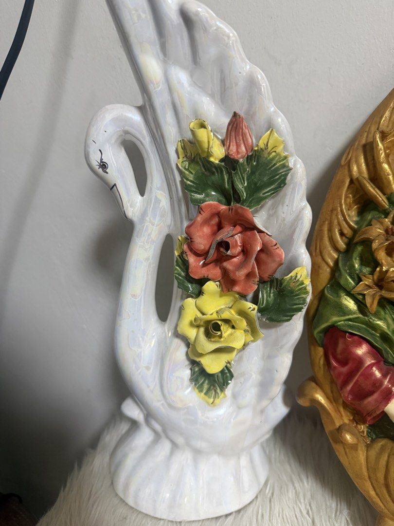 White Swan Figurine with Flowers (Category: Vases & Decorative Bowls) located in Quezon City. Submitted by cristintin (Listing ID 1445417634, Image 1). Description: - Cute white swan figurine with a pearly sheen. - Features colorful sculpted flowers. - Ideal as a standalone decorative piece. - Adds a touch of vintage charm to any room. - Condition: Unnoticeable chips or cracks on flowers.
