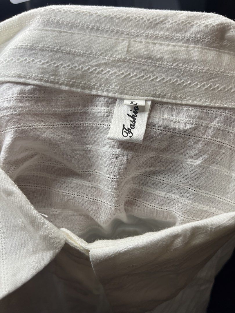 White Textured Long Sleeve Button Up Shirt (Category: Tshirts & Polo Shirts ) located in Baguio. Submitted by gabriyelo (Listing ID 1445374990, Image 3). Description: - Classic white button-up shirt - Subtle textured stripe pattern - Long sleeves with button cuffs - Versatile for any occasion - Great for layering or wearing solo.