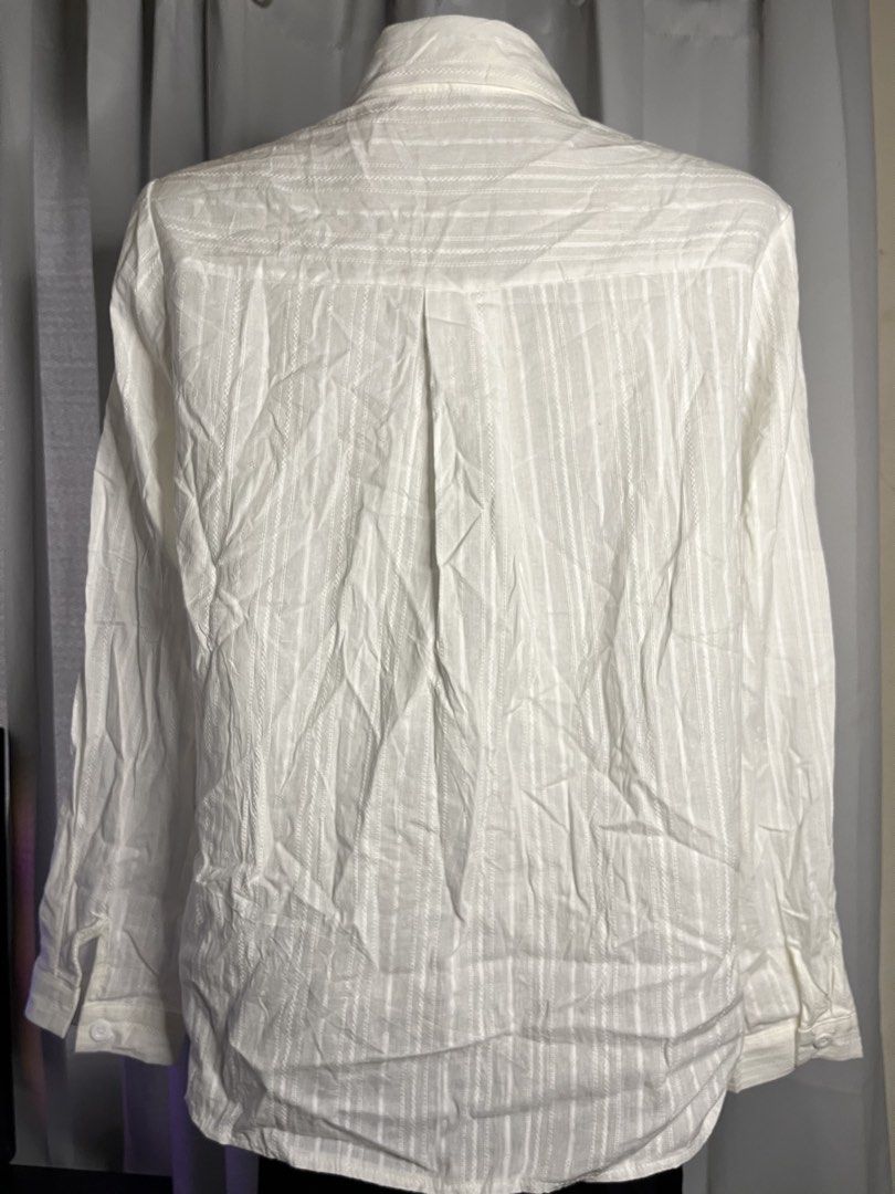 White Textured Long Sleeve Button Up Shirt (Category: Tshirts & Polo Shirts ) located in Baguio. Submitted by gabriyelo (Listing ID 1445374990, Image 2). Description: - Classic white button-up shirt - Subtle textured stripe pattern - Long sleeves with button cuffs - Versatile for any occasion - Great for layering or wearing solo.