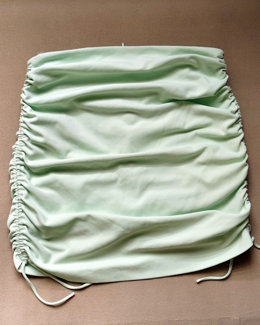 (L) ZARA Mint Green Ruched Drawstring Mini Skirt (Category: Skirts) located in Marikina City. Submitted by marrisoncollection (Listing ID 1445287492, Image 3). Description: - Mint green ruched mini skirt - Brand: ZARA - Features adjustable drawstring sides for a custom fit - Zipper closure at the back - Versatile: great for a night out or casual day - Style tip: Pair with a cute top -like new no flaws -color still excellent RFS: decluttering/down