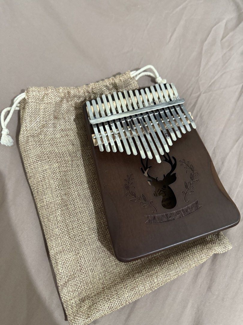 17-Key Kalimba Thumb Piano with Pouch (Category: Musical Instruments) located in Manila. Submitted by ririjeon (Listing ID 1445490220, Image 1). Description: - Beautiful wooden 17-key Kalimba - Features charming deer engraving and floral accents - Comes with a convenient drawstring pouch for storage and travel - Ideal for beginners and aspiring musicians - Easy to learn and produces a lovely, soothing sound.