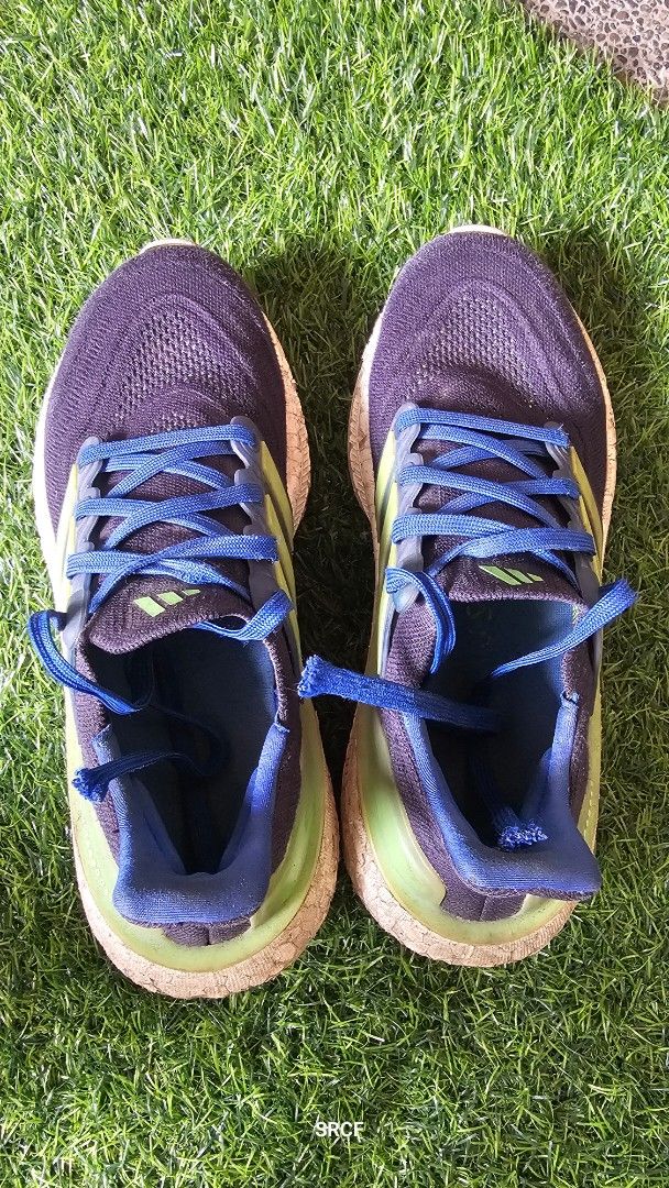 Adidas Ultraboost Running Shoes (Category: Sneakers) located in Quezon City. Submitted by geminimomma2 (Listing ID 1445430389, Image 1). Description: - Adidas Ultraboost running shoes - Color: Dark blue with green accents - Features: Boost midsole for superior comfort - Versatile: Ideal for running or casual wear - Condition: Shows some signs of wear on soles and uppers, but still has plenty of life remaining. Size: US 5.5.
