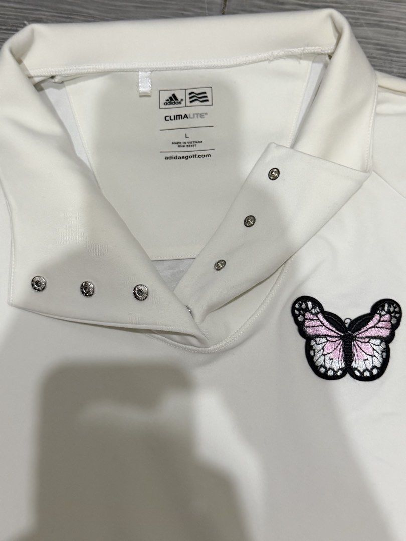 Authentic Adidas CLIMALITE Long Sleeve Pullover with Butterfly Detail (Category: Activewear) located in Iligan City. Submitted by jytomps (Listing ID 1445558424, Image 3). Description: - Dirty White Adidas long sleeve pullover - Size: L - Snap-button collar - Cute pink and black butterfly patch on chest - CLIMALITE material for comfort - Ideal for golf or casual wear -From the US -RFS need funds .