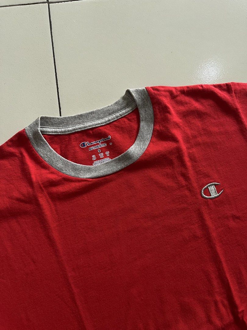Authentic Champion Red T-shirt with Grey Trim (Category: Tshirts & Polo Shirts ) located in Quezon City. Submitted by mbaut (Listing ID 1445502524, Image 2). Description: - Classic red Champion t-shirt - Grey trim on collar and sleeves - Small embroidered Champion logo on chest - Estimated size: Small (S) - Ideal for casual everyday wear.