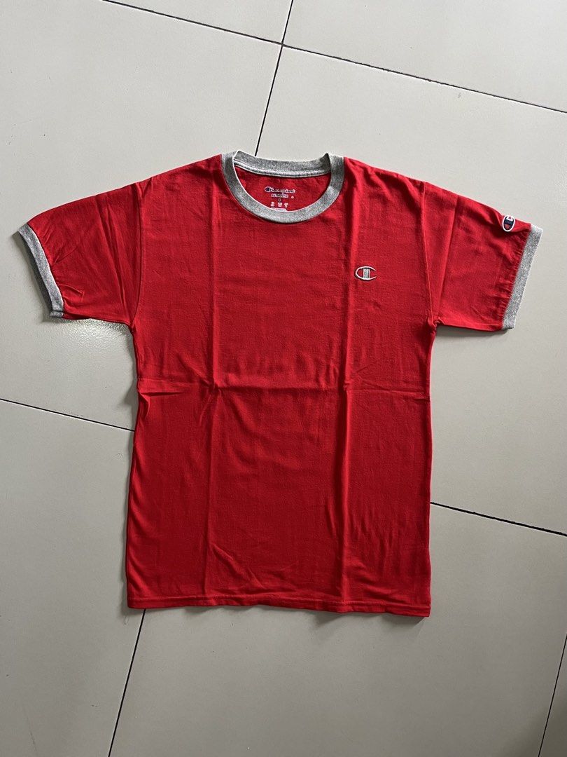 Authentic Champion Red T-shirt with Grey Trim (Category: Tshirts & Polo Shirts ) located in Quezon City. Submitted by mbaut (Listing ID 1445502524, Image 1). Description: - Classic red Champion t-shirt - Grey trim on collar and sleeves - Small embroidered Champion logo on chest - Estimated size: Small (S) - Ideal for casual everyday wear.