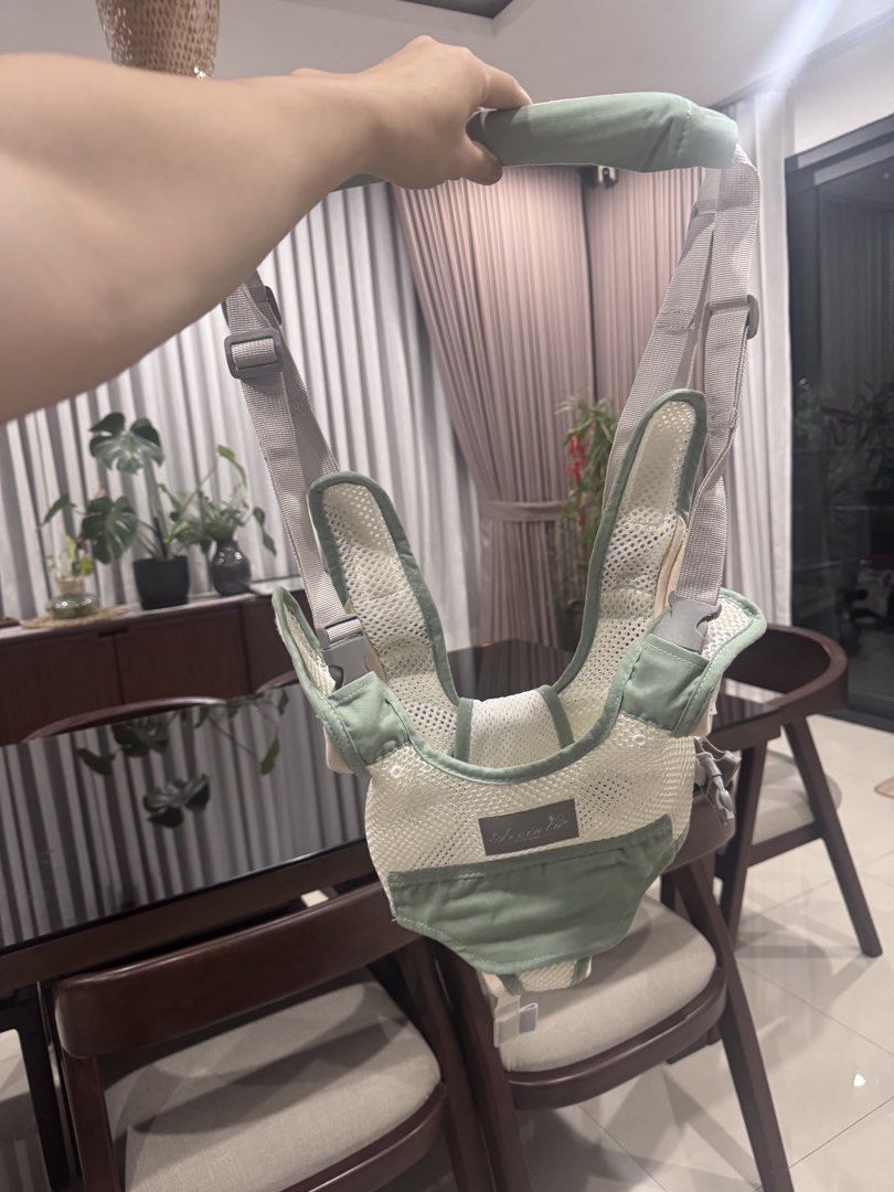Baby Carrier Harness Walker (Category: Carriers & Slings) located in San Fernando. Submitted by kmscloset (Listing ID 1445591949, Image 1). Description: - Light green and white mesh baby carrier - Adjustable straps for a comfortable fit - Aids in baby's walking development - Simple to put on and take off - Ideal for keeping baby close and allowing exploration.