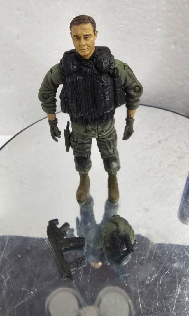 BBI 3.75" [1/18 Scale] Black Hawk Helicopter Pilot Figure (Category: Figurines & Statues) located in Baguio. Submitted by bitsbaguio (Listing ID 1445503432, Image 2). Description: - Detailed military action figure - Stands on a reflective surface - Perfect for collectors and display enthusiasts - Display base not included.