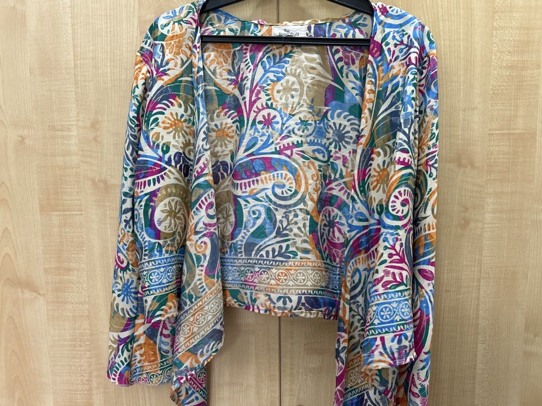 Bigg Bull by Cami Kimono Wrap Top (Category: Others Tops) located in Manila. Submitted by tprdo09 (Listing ID 1445497266, Image 2). Description: - Lightweight kimono style top - Vibrant paisley print - Tie front closure - Wide sleeves - Versatile: wear open as a cardigan or tied as a wrap top - Ideal for layering over any outfit.