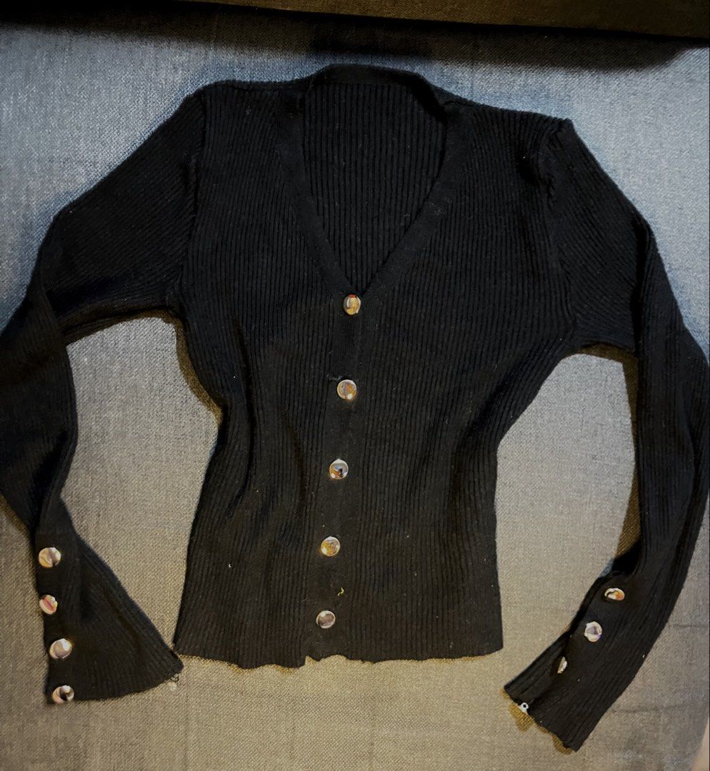 Black Ribbed Button-Up Cardigan with Gold Buttons (Category: Coats, Jackets and Outerwear) located in Manila. Submitted by roseiiiii (Listing ID 1445585978, Image 1). Description: - Black ribbed knit cardigan - Long sleeves with button cuff details - V-neckline with silver button front closure - Fitted silhouette - Versatile for layering or wearing solo.