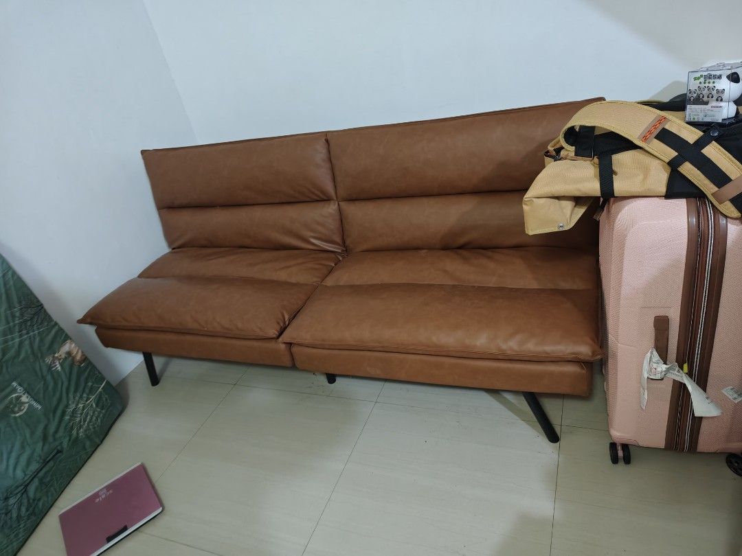 Brown Faux Leather Sofa Bed Futon (Category: Sofas) located in Manila. Submitted by cosmicrabbit-c5bc (Listing ID 1445539972, Image 1). Description: - Brown faux leather sofa bed - 2-seater design - Folds down flat for extra sleeping space - Ideal for small apartments or guest rooms - Easy-to-wipe clean material - Sturdy black metal legs - Versatile style fits most living rooms.