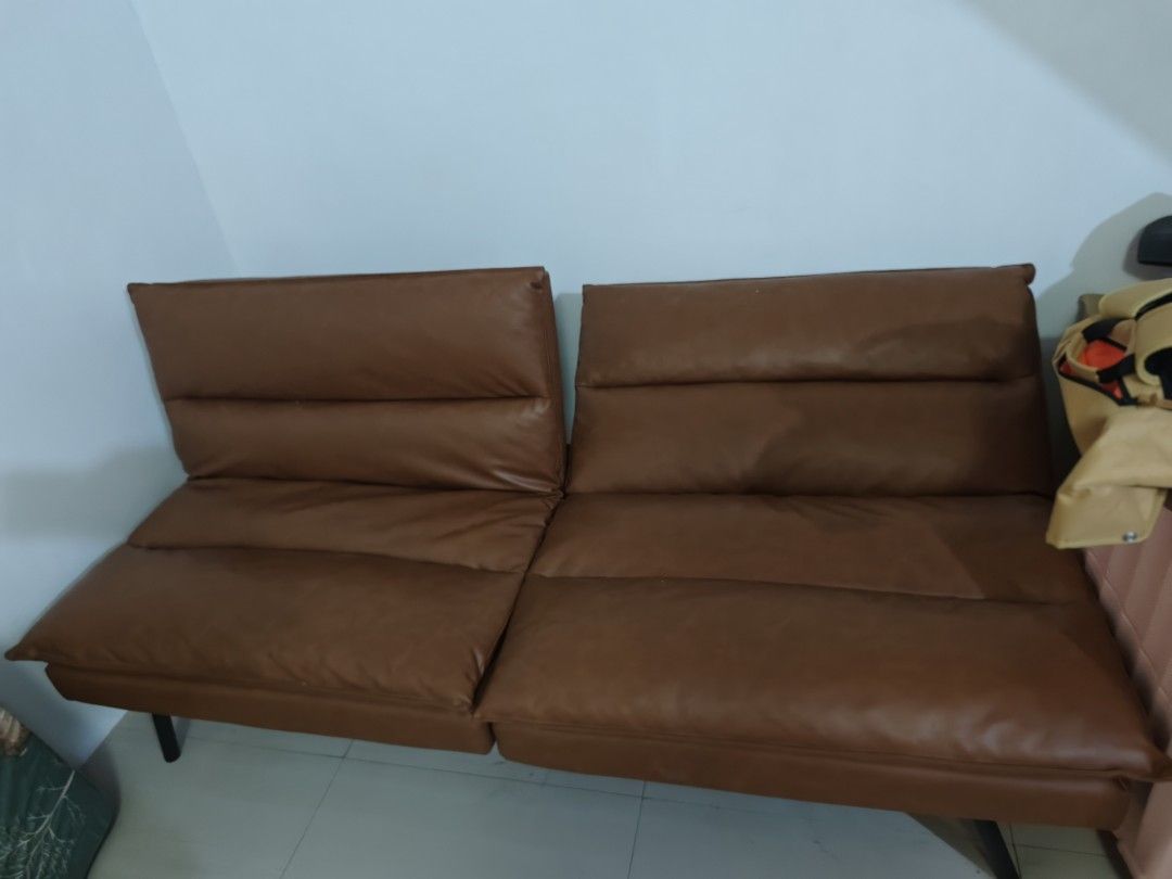 Brown Faux Leather Sofa Bed Futon (Category: Sofas) located in Manila. Submitted by cosmicrabbit-c5bc (Listing ID 1445539972, Image 2). Description: - Brown faux leather sofa bed - 2-seater design - Folds down flat for extra sleeping space - Ideal for small apartments or guest rooms - Easy-to-wipe clean material - Sturdy black metal legs - Versatile style fits most living rooms.