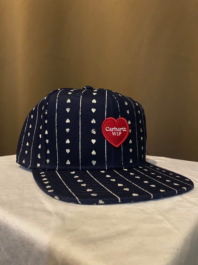 Carhartt WIP Navy Heart Pattern Snapback Cap (Category: Caps & Hats) located in Tarlac. Submitted by LStuff (Listing ID 1445434886, Image 3). Description: - Navy blue Carhartt WIP snapback cap - All-over white heart and pinstripe pattern - Red heart patch with white 'Carhartt WIP' logo on the front - Adjustable snapback closure at the back - Ideal for casual wear 3k.