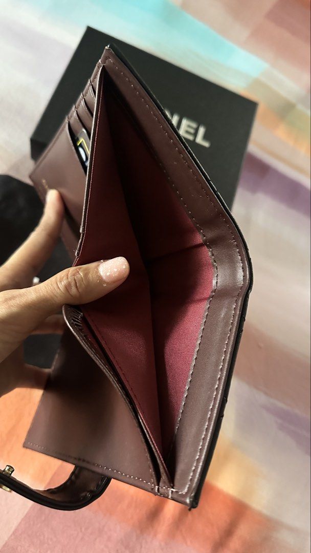 Chanel Quilted Leather Bi-Fold Wallet Black (Category: Luxury Bags & Wallets) located in Makati City. Submitted by janeabat (Listing ID 1445490924, Image 3). Description: Original GWP - Authentic GWP Chanel Wallet - Classic Black Quilted Leather - Luxurious Deep Burgundy Interior - Features Zippered Coin Pocket - Multiple Card Slots - Comes with Original Box - Includes Authenticity Card - Made in Italy.