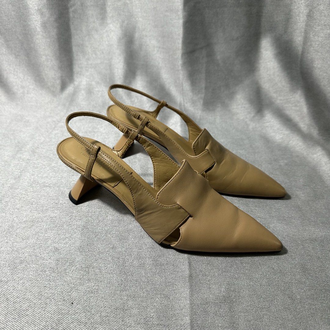 Charles & Keith Slingback Heels Beige Pointed Toe Kitten Heel (Category: Heels) located in Bayombong. Submitted by rochelle_archive_garments (Listing ID 1445577603, Image 1). Description: - Brand: Charles & Keith - Color: Beige - Style: Slingback heels - Toe: Pointed - Heel: Low kitten heel - Details: Side cut-outs, adjustable ankle strap - Condition: Minor scuffs on toe tips - Occasion: Dress up or down.