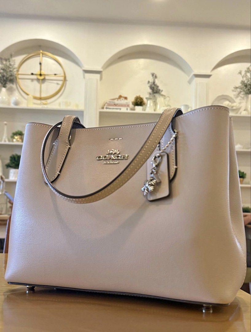 Coach Avenue (Category: Luxury Bags & Wallets) located in Carmona. Submitted by dangsg (Listing ID 1445547900, Image 1). Description: - 2-way handbag (hand carry or shoulder wear) - Detachable crossbody strap included - perfect for everyday errands, office days, school, casual outings, or travel. - Spacious interior for your daily essentials - Base is sturdy - Neutral beige/grey color RFS: di nagamit since nabili 📍Cavite.