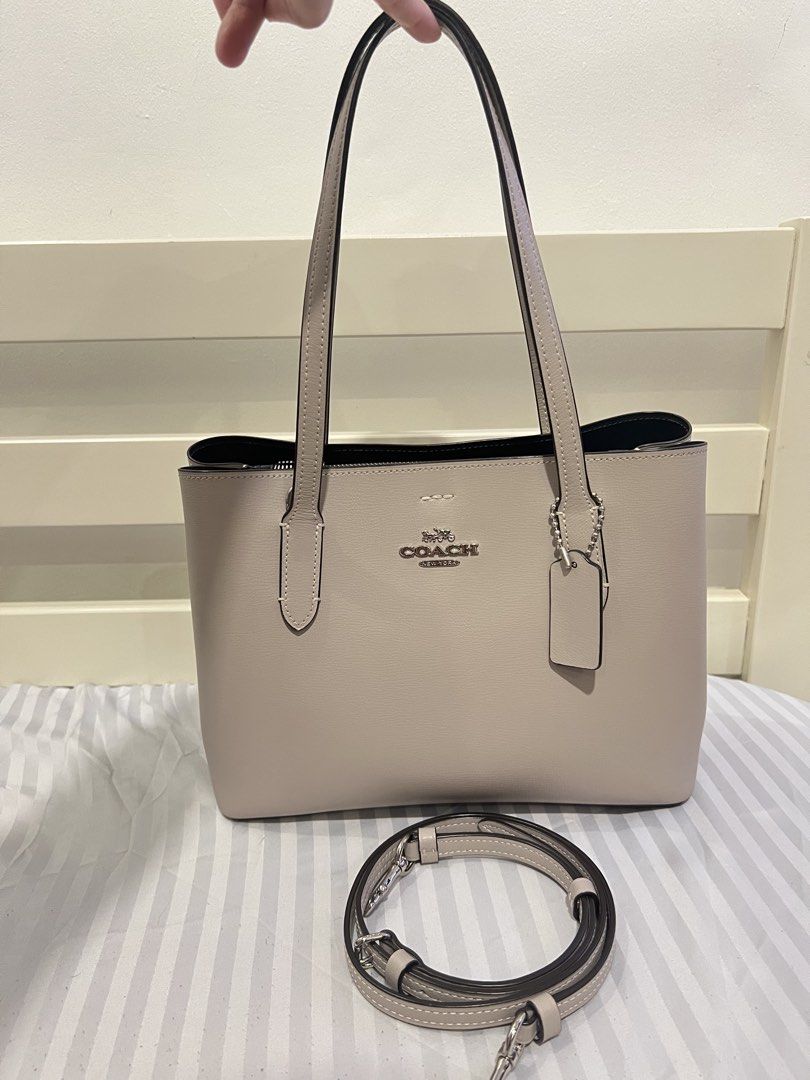 Coach Avenue (Category: Luxury Bags & Wallets) located in Carmona. Submitted by dangsg (Listing ID 1445547900, Image 3). Description: - 2-way handbag (hand carry or shoulder wear) - Detachable crossbody strap included - perfect for everyday errands, office days, school, casual outings, or travel. - Spacious interior for your daily essentials - Base is sturdy - Neutral beige/grey color RFS: di nagamit since nabili 📍Cavite.