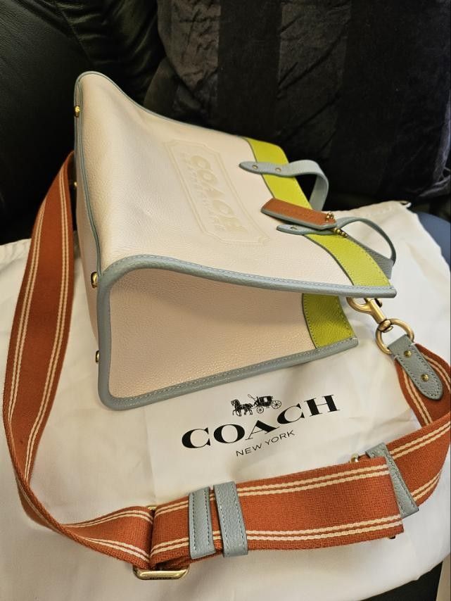 Coach Field Tote 30 Bag with Orange Strap (Category: Luxury Bags & Wallets) located in Quezon City. Submitted by shadykey (Listing ID 1445587395, Image 2). Description: Coach Field Tote 30 Authentic Coach Field Tote 30 in Colorblock with Coach Badge Selling a 100% authentic Coach Field Tote 30 featuring the iconic Coach Badge. It is a brand-new bag that can be carried by hand or worn as a shoulder/crossbody bag. PHP 25,000 (can nego for sure buye