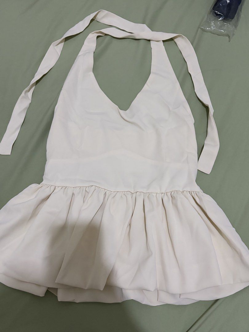 Cream Halter Neck Peplum Top with Smocked Back (Category: Sleeveless) located in Cainta. Submitted by dansbmcl (Listing ID 1445543777, Image 1). Description: - Cream halter neck top - Peplum style with ruffled hem - Smocked back for a comfortable fit - Ties at the neck - Estimated size M/L - Perfect for dressing up or down.