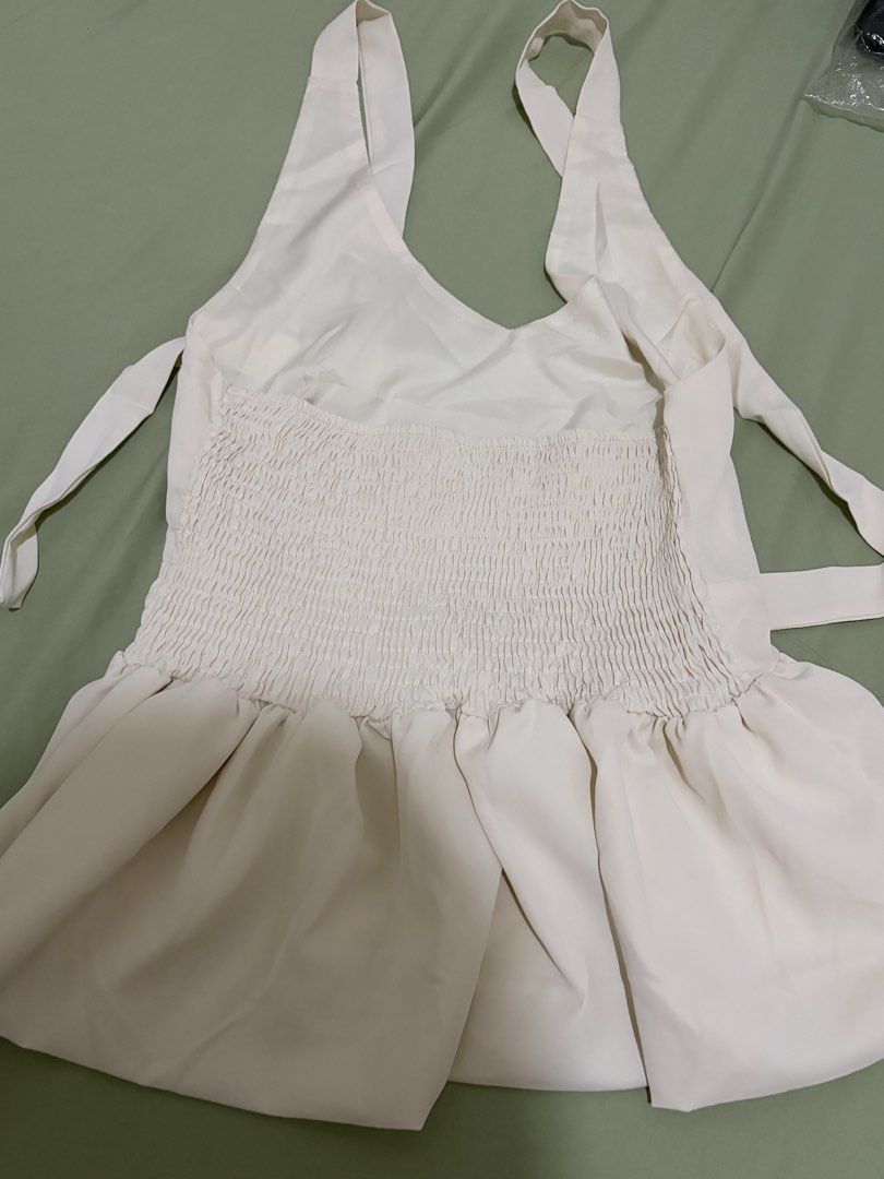 Cream Halter Neck Peplum Top with Smocked Back (Category: Sleeveless) located in Cainta. Submitted by dansbmcl (Listing ID 1445543777, Image 2). Description: - Cream halter neck top - Peplum style with ruffled hem - Smocked back for a comfortable fit - Ties at the neck - Estimated size M/L - Perfect for dressing up or down.