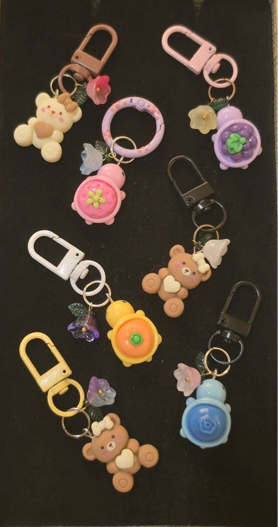 Cute Animal & Fruit Themed Keychains with Charms (Category: Character Goods) located in Los Banos. Submitted by acgalamgam (Listing ID 1445490526, Image 3). Description: - Adorable handmade keychains featuring bears, bunnies, turtles, and fruit designs. - Each keychain includes a colorful hoop and a flower charm. - Ideal for decorating bags, backpacks, or as a personal accessory. - Mix and match your favorite designs! - Available for purchase ind