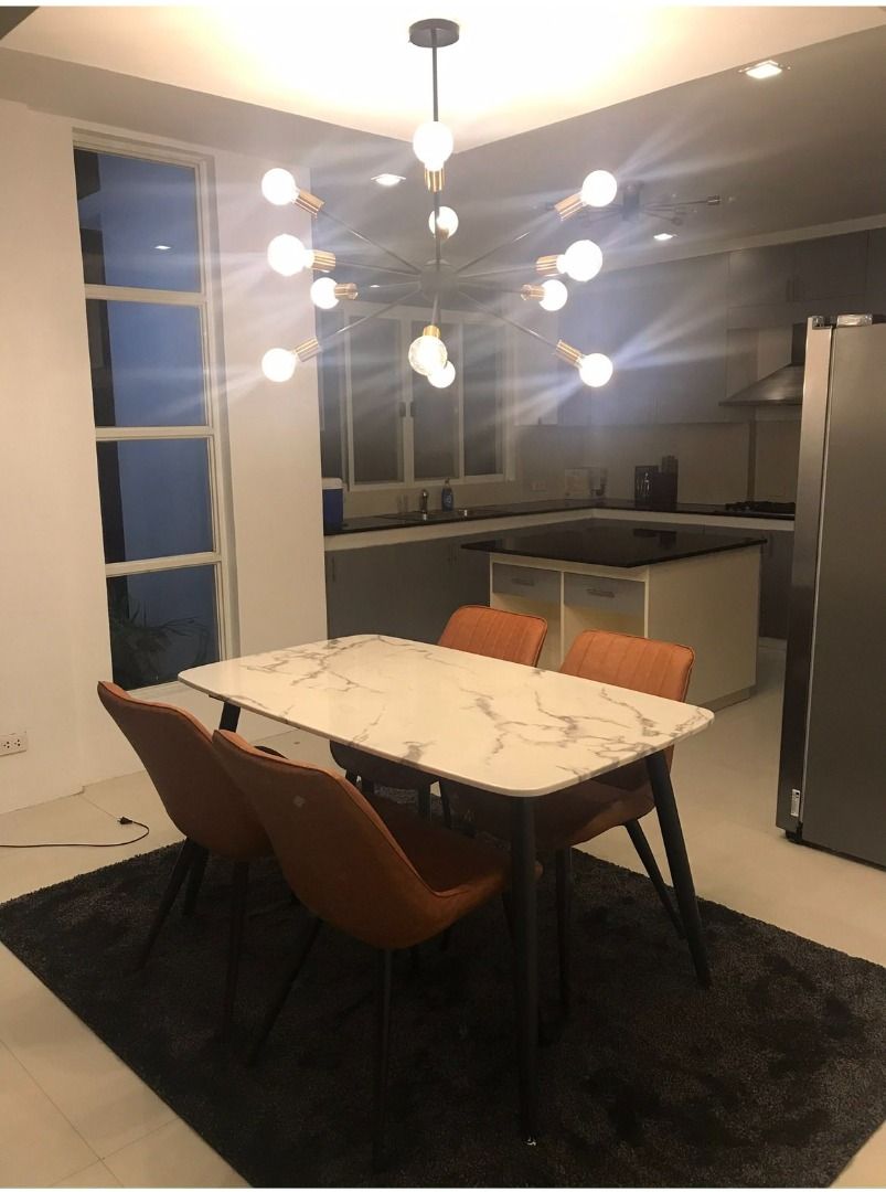 Dining Table (Category: Tables & Sets) located in Manila. Submitted by czaimalana (Listing ID 1445576856, Image 1). Description: Modern marble-top dining table with dark legs. Comes with four comfortable orange upholstered chairs. Perfect for a dining area or kitchen nook. Seats four people comfortably. The marble pattern is unique and adds a stylish touch to any home. Easy to clean surface..