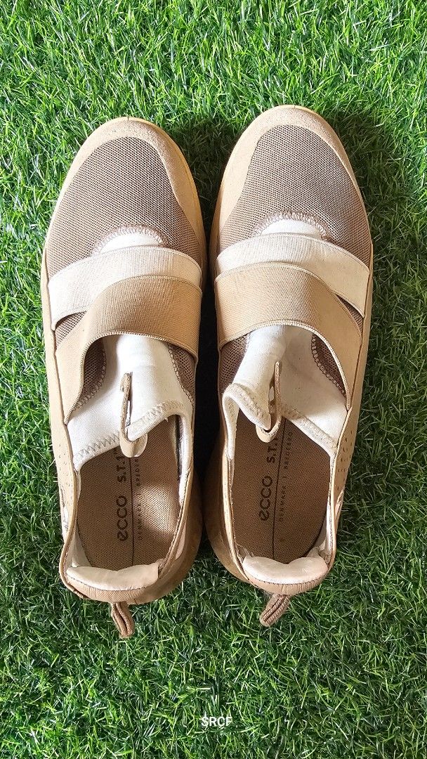 ECCO S.T.1 Lite Slip-On Sneakers (Category: Sneakers) located in Quezon City. Submitted by geminimomma2 (Listing ID 1445434304, Image 1). Description: - ECCO S.T.1 Lite slip-on sneakers - Color: Tan and beige mesh - Features elastic straps for easy wear - Known for comfort and everyday practicality - Soles show some signs of wear.