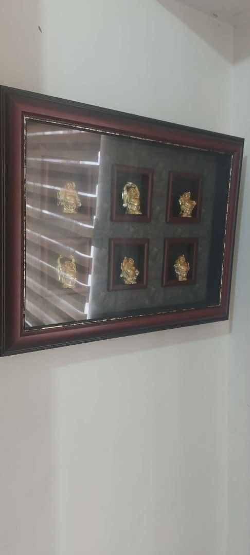 Framed Gold Figurines Wall Art (Category: Wall Decor) located in Bulacan. Submitted by HomeProductsMNL (Listing ID 1445555182, Image 1). Description: - Framed wall art with 6 gold Buddha - Dark wood frame - Textured grey background - Each figurine in its own small square frame - Ideal for home decor - Enhances any room's aesthetic.