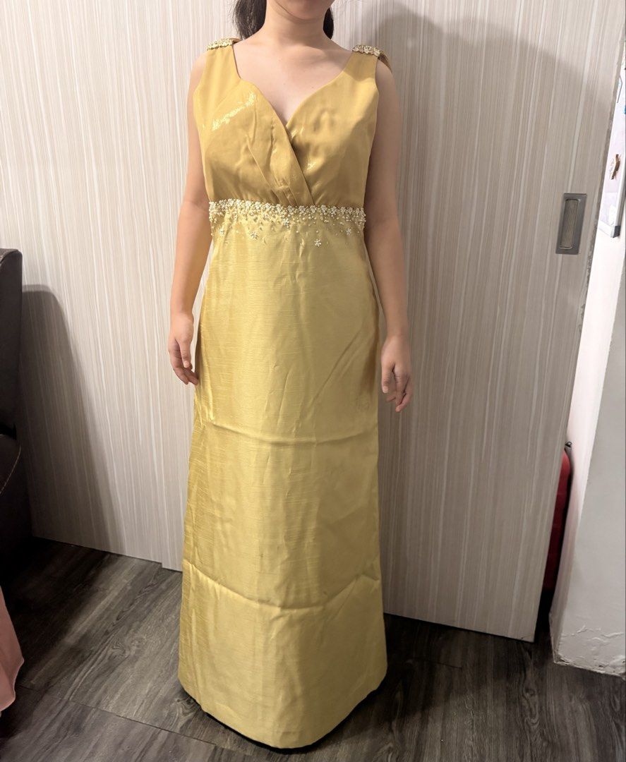 Gold Embellished Maxi Dress (Category: Dresses) located in Taguig. Submitted by _annaq_ (Listing ID 1445496420, Image 1). Description: - Elegant gold maxi dress - Sleeveless with a flattering V-neckline - Intricate beadwork and embellishments on waist and shoulders - Flowy, layered skirt for a graceful silhouette - Perfect for formal events, parties, or special occasions - Convenient back zipper closure For everyone’s fairness and transparency, k