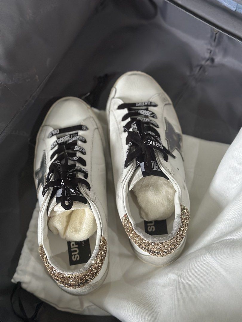 Golden Goose Superstar Sneakers (Category: Sneakers) located in Baybay. Submitted by styleonpoint (Listing ID 1438518937, Image 3). Description: - Golden Goose Superstar sneakers - White leather upper - Glitter heel tab - Silver star detail - Distressed sole - Black laces - Brand name on side and tongue.
