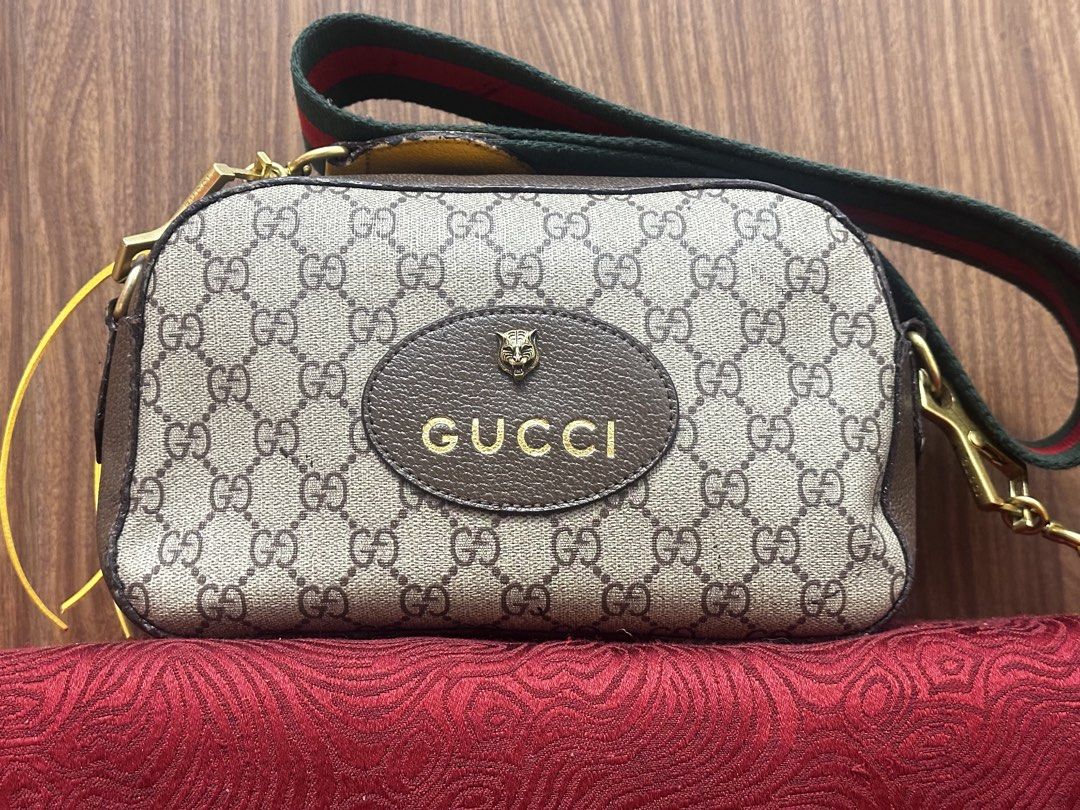 Gucci GG Supreme Tiger Head Crossbody Bag (Category: Luxury Bags & Wallets) located in Antipolo. Submitted by happinessprelove (Listing ID 1445554607, Image 3). Description: - Authentic Gucci crossbody bag - Classic GG Supreme canvas - Iconic tiger head and Gucci logo on front - Signature green and red stripe strap - Interior with floral print lining - Ideal for everyday use.