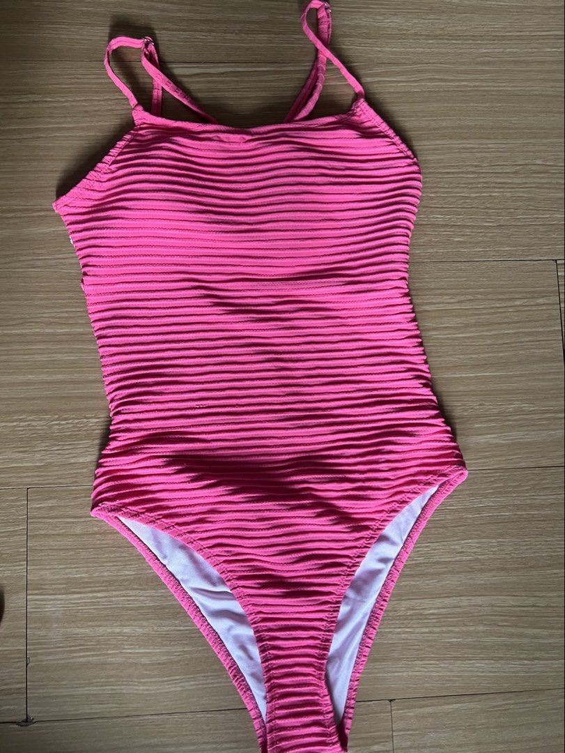 Hot Pink Ribbed One-Piece Swimsuit (Category: Bikinis & Swimsuits) located in Makati City. Submitted by nat____ (Listing ID 1445507830, Image 1). Description: - NEVER WORN - Thin straps with a chic criss-cross back detail - Convenient clasp closure at the back - Adjustable sleeves - Size can fit S-M.