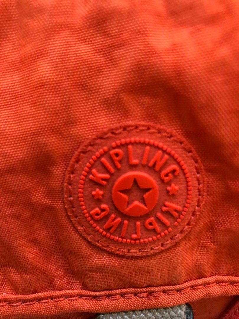 Kipling Orange Nylon Shoulder Bag with Monkey Charm (Category: Shoulder Bags) located in Davao. Submitted by 4mscllection (Listing ID 1445583531, Image 3). Description: - Vibrant orange Kipling bag - Made from durable nylon material - Convenient front pocket with drawstring closure - Includes a detachable shoulder strap for versatile carrying - Comes with the iconic Kipling monkey charm - All zippers are in excellent working condition - Ideal for